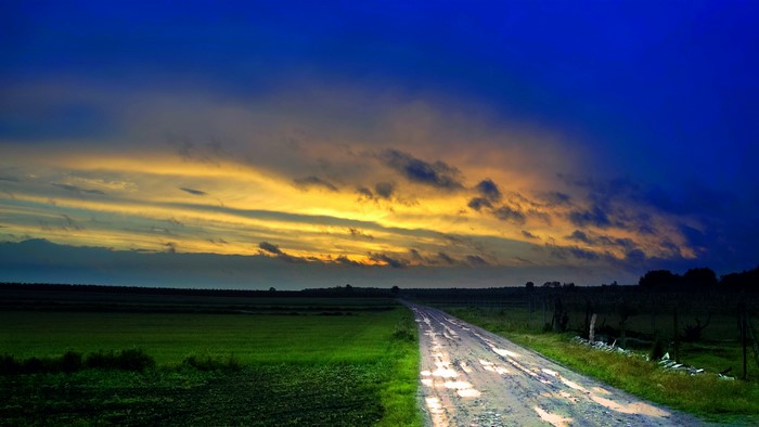 4K Country road with dramatic sunset sky