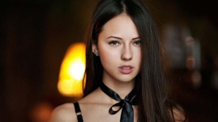 Young woman with dark hair and black ribbon
