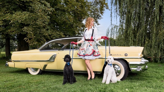 Woman with two dogs and a retro car