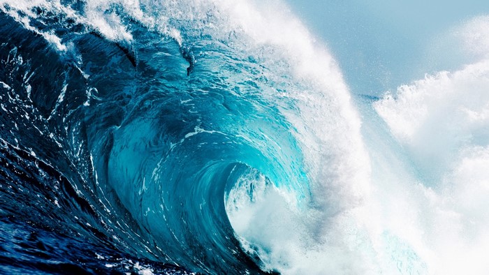 Massive blue ocean wave crashing