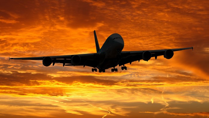 Airplane flying during a vibrant sunset