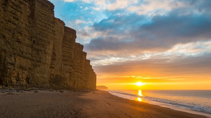 Sunrise over the sea cliffs at West Bay, England