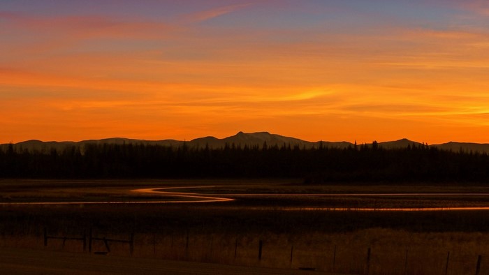 Sunset over mountains and river