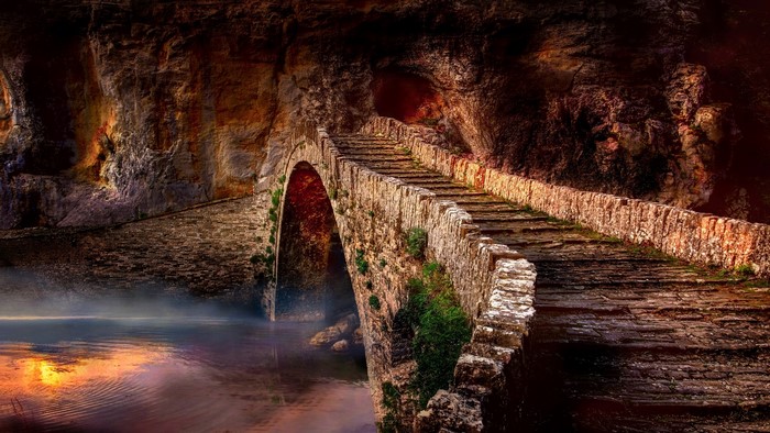 Stone bridge over a river in a cave