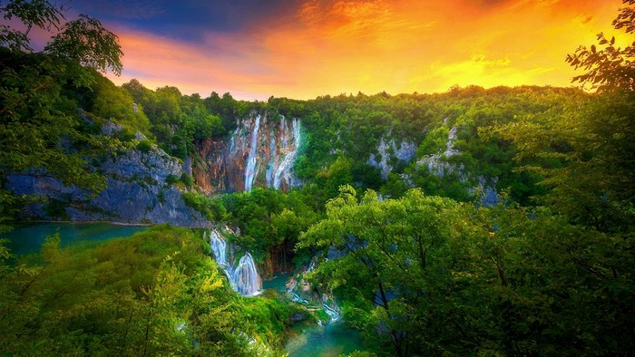 Waterfalls and forest at sunset