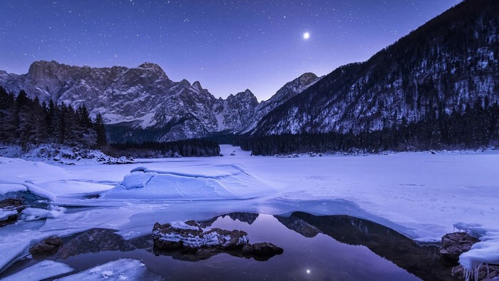 Winter night sky over Italian Alps at Fusine
