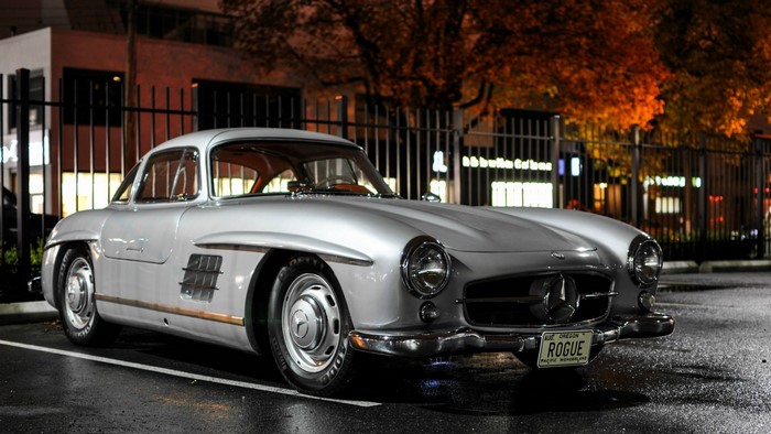 Silver Mercedes-Benz 300SL Gullwing parked at night