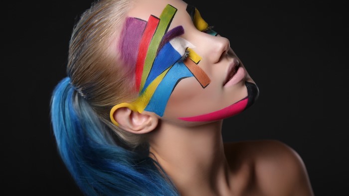 Woman with colorful geometric face paint