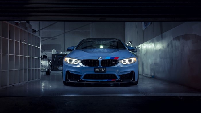 Blue BMW M4 in a garage