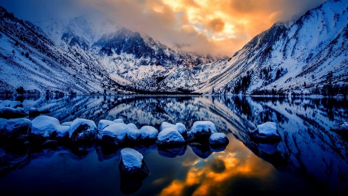 Snowy Mountains Reflecting in a Lake at Sunset
