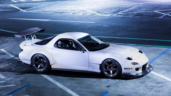 White Mazda RX-7 with large rear spoiler