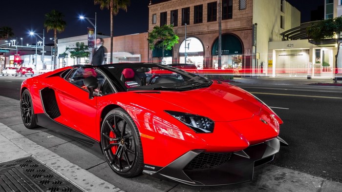Red Lamborghini Aventador Roadster on City Street at Night