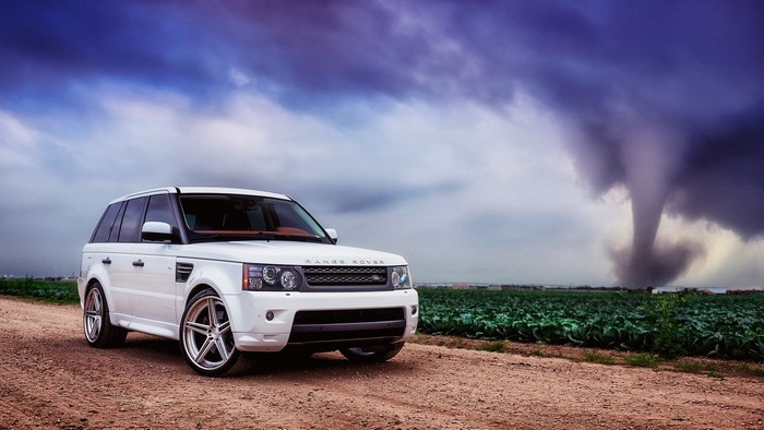 White Range Rover in front of a tornado