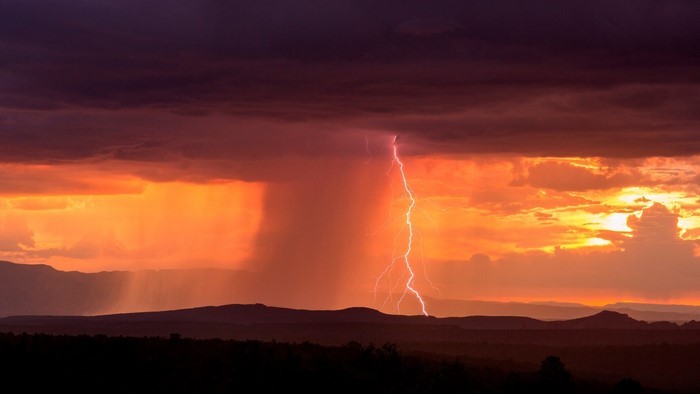 Lightning strike over Arizona landscape at sunset