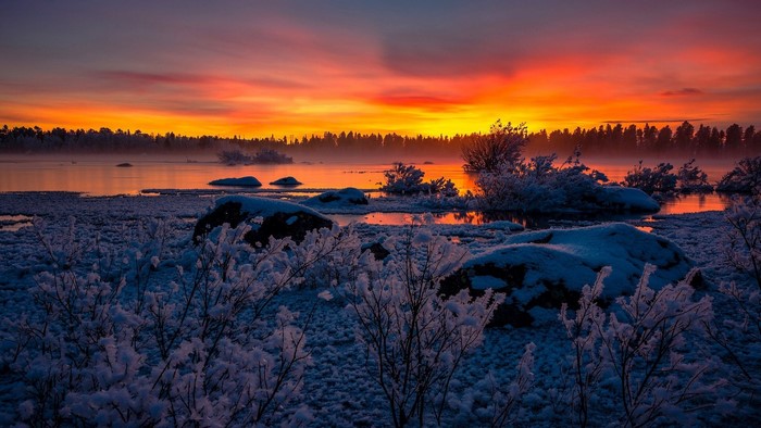 Sunset over frozen lake in Swedish Lapland