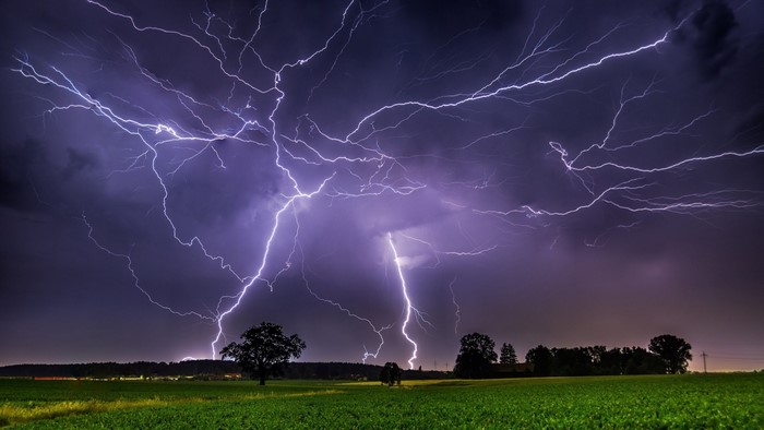 Thunderstorm with lightning over a field