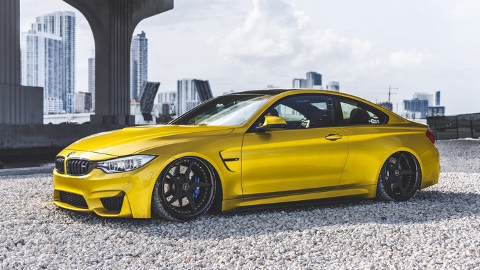 Yellow BMW M4 Coupe on Gravel