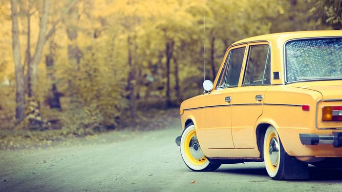 Yellow Vaz 2106 car on a dirt road