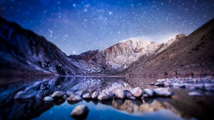 Starry night over a mountain lake