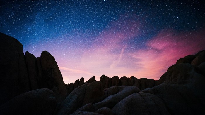 Night sky with stars over rock formations