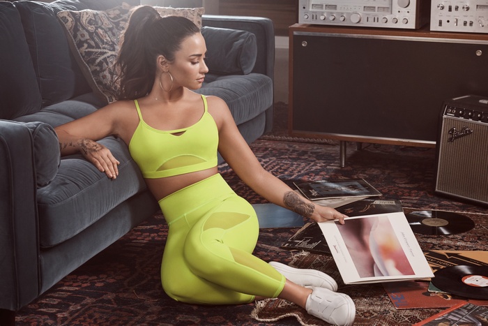 Demi Lovato in Neon Yellow Athletic Wear with Records