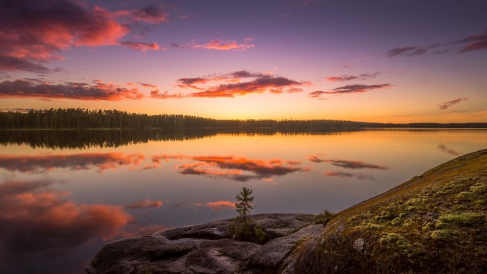 Sunset over a Finnish lake with colorful clouds