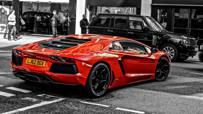 Red Lamborghini Aventador LP 700-4 and black Range Rover