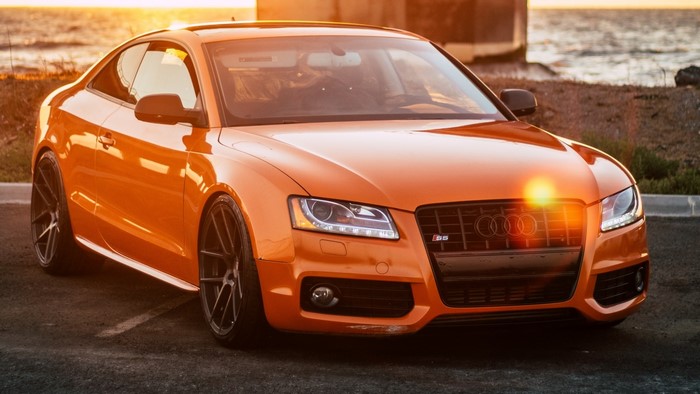 Orange Audi S5 Coupe by the water