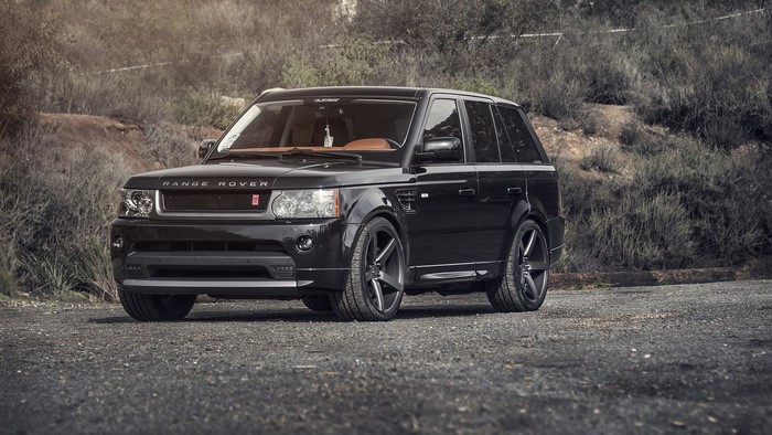 Black Range Rover Sport parked on gravel