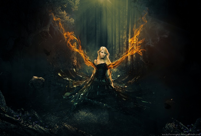 Fantasy girl with flame wings in a dark forest