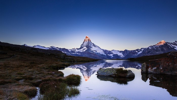 Matterhorn mountain reflected in a lake at sunrise