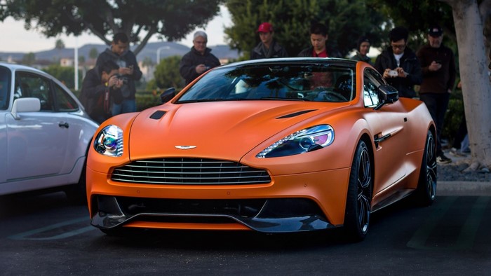 Orange Aston Martin Vanquish parked outdoors