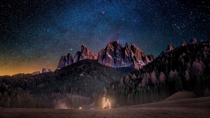 Church under starry sky in Dolomites