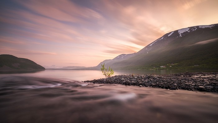 Long exposure of a lake and mountains at sunset