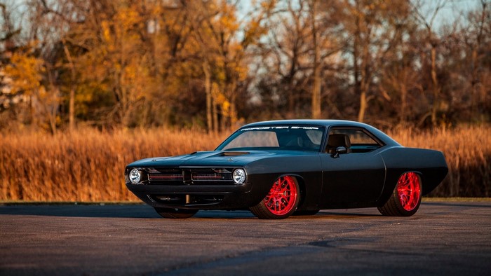 Black 1972 Plymouth Barracuda with red wheels