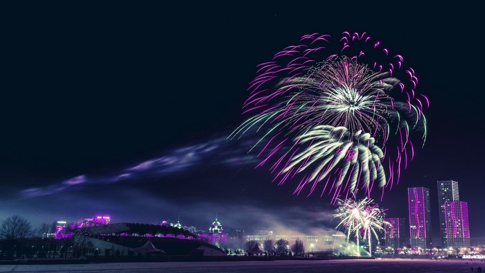 Fireworks over a city skyline at night