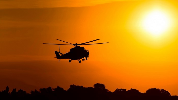 Mi-24 helicopter flying at sunset
