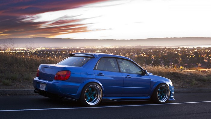 Blue Subaru Impreza STI at sunset