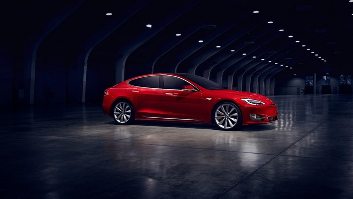 Red Tesla Model S P100D in a dark hall