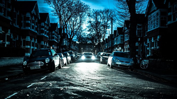 Street at night with cars and houses in London