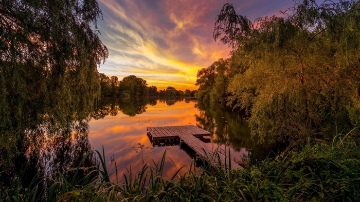 Wooden pier on a lake at sunset