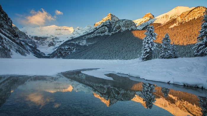Snowy Mountains and Frozen Lake Reflection