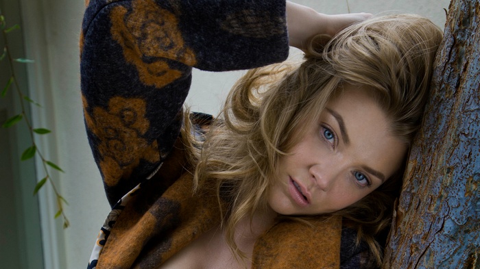 Natalie Dormer leaning against a tree