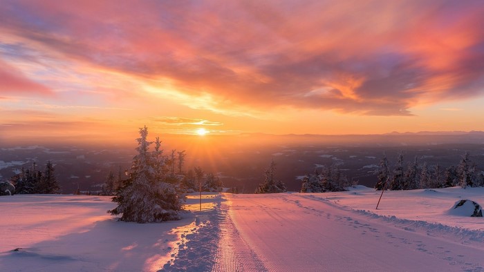 Snowy mountain road at sunset