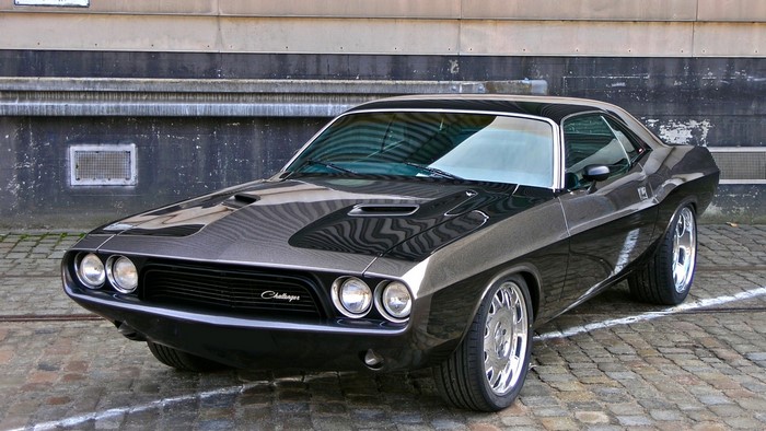 Black Dodge Challenger parked on cobblestone street