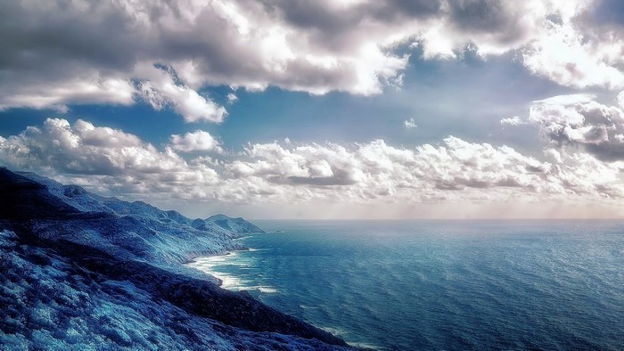 Blue Mountains meet the Sea under Cloudy Sky