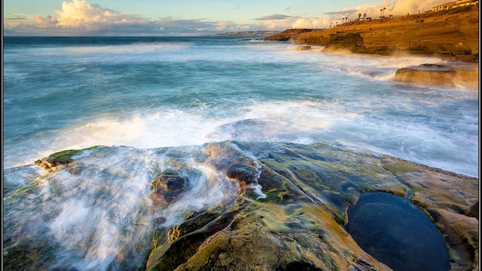 Ocean waves crashing on rocky shore in California
