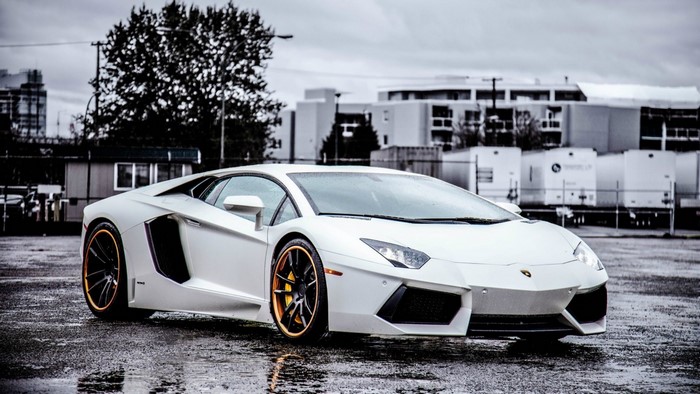 White Lamborghini Aventador LP 700-4 on wet asphalt