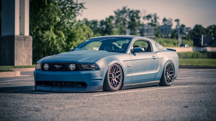 Blue Ford Mustang parked in a lot