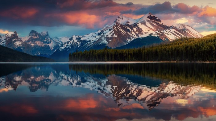 Snowy Mountains Reflected in a Calm Lake at Sunset